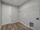Simple laundry room with luxury vinyl plank flooring at 42 Mountain Dr, Babson Park, FL 33827