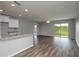 Spacious living room with wood-look flooring, a ceiling fan, and sliding glass doors to the outdoors at 42 Mountain Dr, Babson Park, FL 33827