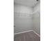 Simple walk-in closet with wire shelves and neutral carpet and paint at 42 Mountain Dr, Babson Park, FL 33827