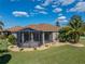 Aerial view of home exterior with well maintained lawn, landscaping, and screened in lanai at 4232 Roebelenii Dr, Lake Wales, FL 33859