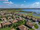 Scenic aerial view featuring a residential community near a golf course and a large lake at 4232 Roebelenii Dr, Lake Wales, FL 33859