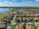 Wide aerial view of a residential community with mature trees and scenic lakes in the distance at 4232 Roebelenii Dr, Lake Wales, FL 33859