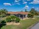 Backyard aerial view featuring mature landscaping, grassy yard, neutral paint color and screened lanai at 4232 Roebelenii Dr, Lake Wales, FL 33859