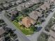 Aerial of well-kept residential property featuring lush landscaping, a brown roof, and a private driveway at 4232 Roebelenii Dr, Lake Wales, FL 33859