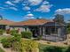 Lush landscaping and green lawn lead up to home featuring a screened patio and neutral paint at 4232 Roebelenii Dr, Lake Wales, FL 33859