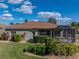 Backyard featuring lush landscaping, well manicured lawn, and an enclosed screened in patio at 4232 Roebelenii Dr, Lake Wales, FL 33859