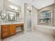 This bathroom features double vanity, bathtub, and a walk-in shower at 4232 Roebelenii Dr, Lake Wales, FL 33859