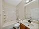 Well-lit bathroom features a tub/shower combination and a vanity with sink at 4232 Roebelenii Dr, Lake Wales, FL 33859