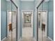This bathroom features double closets, a bathtub, and a walk-in shower at 4232 Roebelenii Dr, Lake Wales, FL 33859