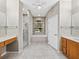 This bathroom features a shower, bathtub, double vanity, and a ceiling fan at 4232 Roebelenii Dr, Lake Wales, FL 33859