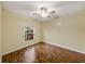 Comfortable bedroom with wood floors and a bright window offering a peaceful view at 4232 Roebelenii Dr, Lake Wales, FL 33859