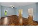 Serene bedroom featuring wood floors, large window, and ensuite bathroom access at 4232 Roebelenii Dr, Lake Wales, FL 33859