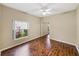 Light bedroom with wood floors, view of a lush garden, and closet with mirrored doors at 4232 Roebelenii Dr, Lake Wales, FL 33859