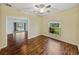 Inviting bedroom features wood floors and views of a lush, green yard at 4232 Roebelenii Dr, Lake Wales, FL 33859