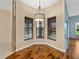 Cozy breakfast nook with wood floors, three windows, and a modern chandelier at 4232 Roebelenii Dr, Lake Wales, FL 33859