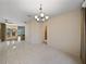 Neutral dining space featuring tile floors, chandelier, neutral walls, with access to other living spaces at 4232 Roebelenii Dr, Lake Wales, FL 33859