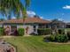 Charming single-story home featuring lush landscaping, a screened lanai, and a well-maintained lawn at 4232 Roebelenii Dr, Lake Wales, FL 33859