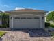 Spacious two-car garage with traditional doors and brick-paved driveway for easy access at 4232 Roebelenii Dr, Lake Wales, FL 33859