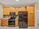 Kitchen featuring wood cabinets, stainless steel appliances, and neutral countertops at 4232 Roebelenii Dr, Lake Wales, FL 33859