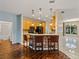 Kitchen with wood cabinets, a breakfast bar, stainless steel appliances, and tile backsplash at 4232 Roebelenii Dr, Lake Wales, FL 33859