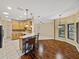 Open kitchen with wood floors, bar seating, and seamless access to the living area at 4232 Roebelenii Dr, Lake Wales, FL 33859