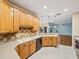 Well-lit kitchen with stainless steel appliances, wood cabinets, and tiled backsplash at 4232 Roebelenii Dr, Lake Wales, FL 33859