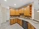 Kitchen with wood cabinets, neutral countertops, and stainless steel appliances at 4232 Roebelenii Dr, Lake Wales, FL 33859