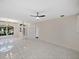 Spacious living room with tile floors, neutral walls, abundant natural light, and high ceilings at 4232 Roebelenii Dr, Lake Wales, FL 33859