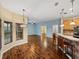 Open concept living area with wood flooring, lots of light and kitchen bar with seating at 4232 Roebelenii Dr, Lake Wales, FL 33859