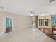 Spacious living room with tile floors, large windows, and a ceiling fan at 4232 Roebelenii Dr, Lake Wales, FL 33859