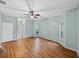 This main bedroom features wood floors, a ceiling fan, and access to a full bathroom at 4232 Roebelenii Dr, Lake Wales, FL 33859