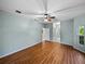 This main bedroom features wood floors, a ceiling fan, and access to a full bathroom at 4232 Roebelenii Dr, Lake Wales, FL 33859