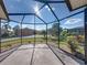 Enclosed patio features views of the lush landscaping and serene lake at 4232 Roebelenii Dr, Lake Wales, FL 33859