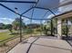 Enclosed patio with views of the manicured backyard and lush landscaping at 4232 Roebelenii Dr, Lake Wales, FL 33859