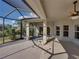 Spacious covered patio with a ceiling fan and views of the manicured backyard at 4232 Roebelenii Dr, Lake Wales, FL 33859
