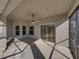 Covered patio features a ceiling fan and views of the lush landscaping at 4232 Roebelenii Dr, Lake Wales, FL 33859
