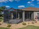 Angle shot of screened patio highlighting neutral exterior paint, landscaping, and roofline of the home at 4232 Roebelenii Dr, Lake Wales, FL 33859