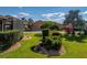 Beautifully landscaped front yard with lush green lawn and decorative plantings surrounding the property at 4232 Roebelenii Dr, Lake Wales, FL 33859