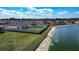Aerial view of the property backing onto a pond with lake in the background at 447 Lanham Dr, Winter Haven, FL 33881