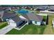 Aerial view of home with a well-manicured lawn, water view, and easy neighborhood access at 447 Lanham Dr, Winter Haven, FL 33881