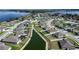 Aerial view of a home in a lakeside community with ponds and green spaces at 447 Lanham Dr, Winter Haven, FL 33881