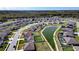 Aerial view of home with backyard pond views in a suburban neighborhood at 447 Lanham Dr, Winter Haven, FL 33881