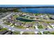 Aerial view of a lakefront home with a pond view in a friendly neighborhood setting at 447 Lanham Dr, Winter Haven, FL 33881