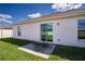 Back patio with sliding glass door opening onto a well-maintained backyard at 447 Lanham Dr, Winter Haven, FL 33881