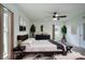 Staged bedroom with contemporary decor, neutral bedding, and abundant natural light at 447 Lanham Dr, Winter Haven, FL 33881