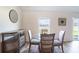 Cozy dining area with a glass table and chairs, complemented by stylish decor at 447 Lanham Dr, Winter Haven, FL 33881