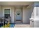Inviting front porch with a light-blue front door, wreath, and outdoor seating area at 447 Lanham Dr, Winter Haven, FL 33881
