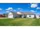 Well-maintained home with a two-car garage, landscaped yard, and inviting entrance at 447 Lanham Dr, Winter Haven, FL 33881