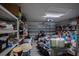 Attached two car garage showing clutter on floor and shelves along the walls at 447 Lanham Dr, Winter Haven, FL 33881