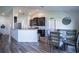 Open-concept kitchen and dining area featuring dark cabinets and modern decor at 447 Lanham Dr, Winter Haven, FL 33881